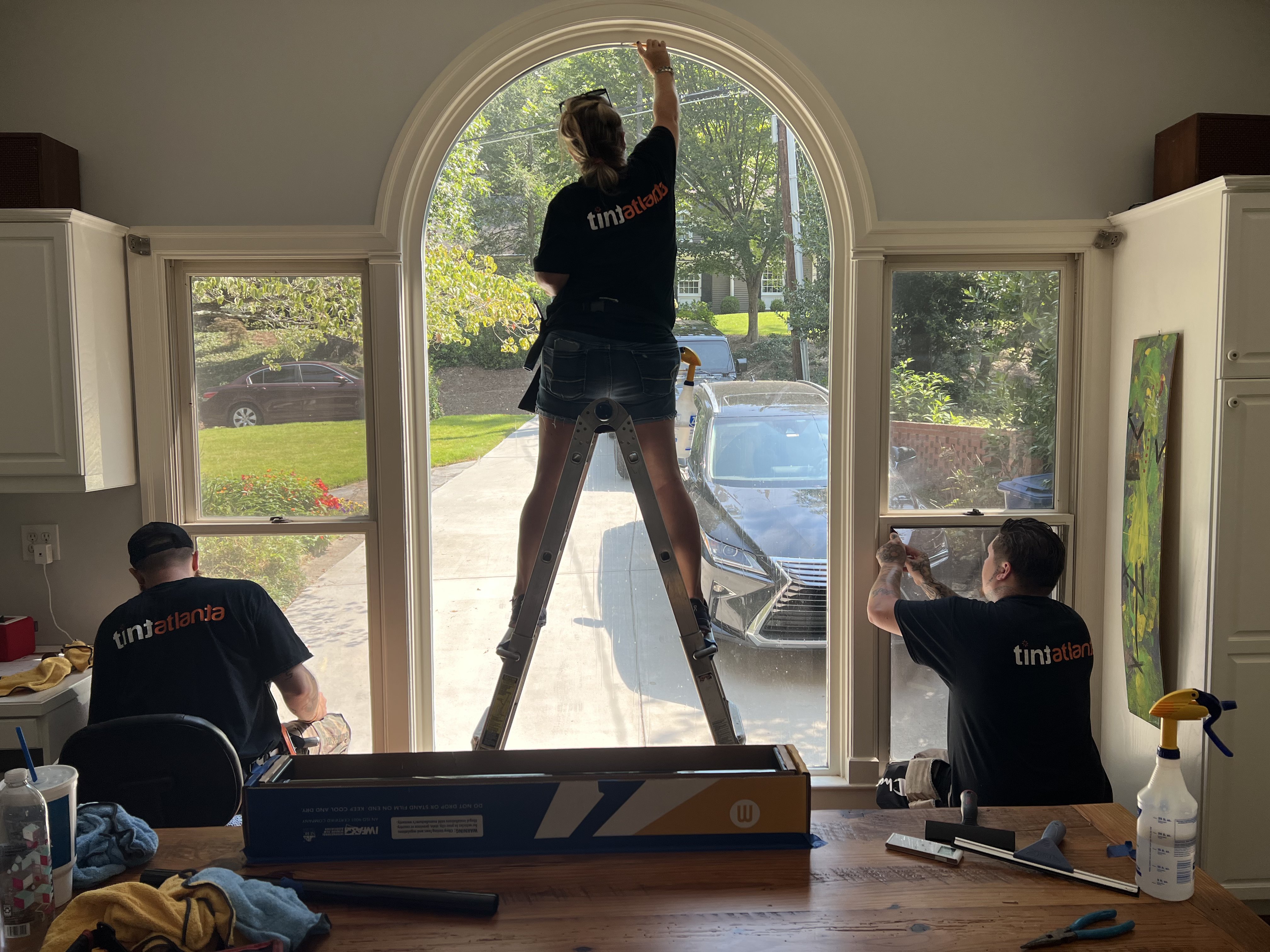 TintButler team installing residential window film